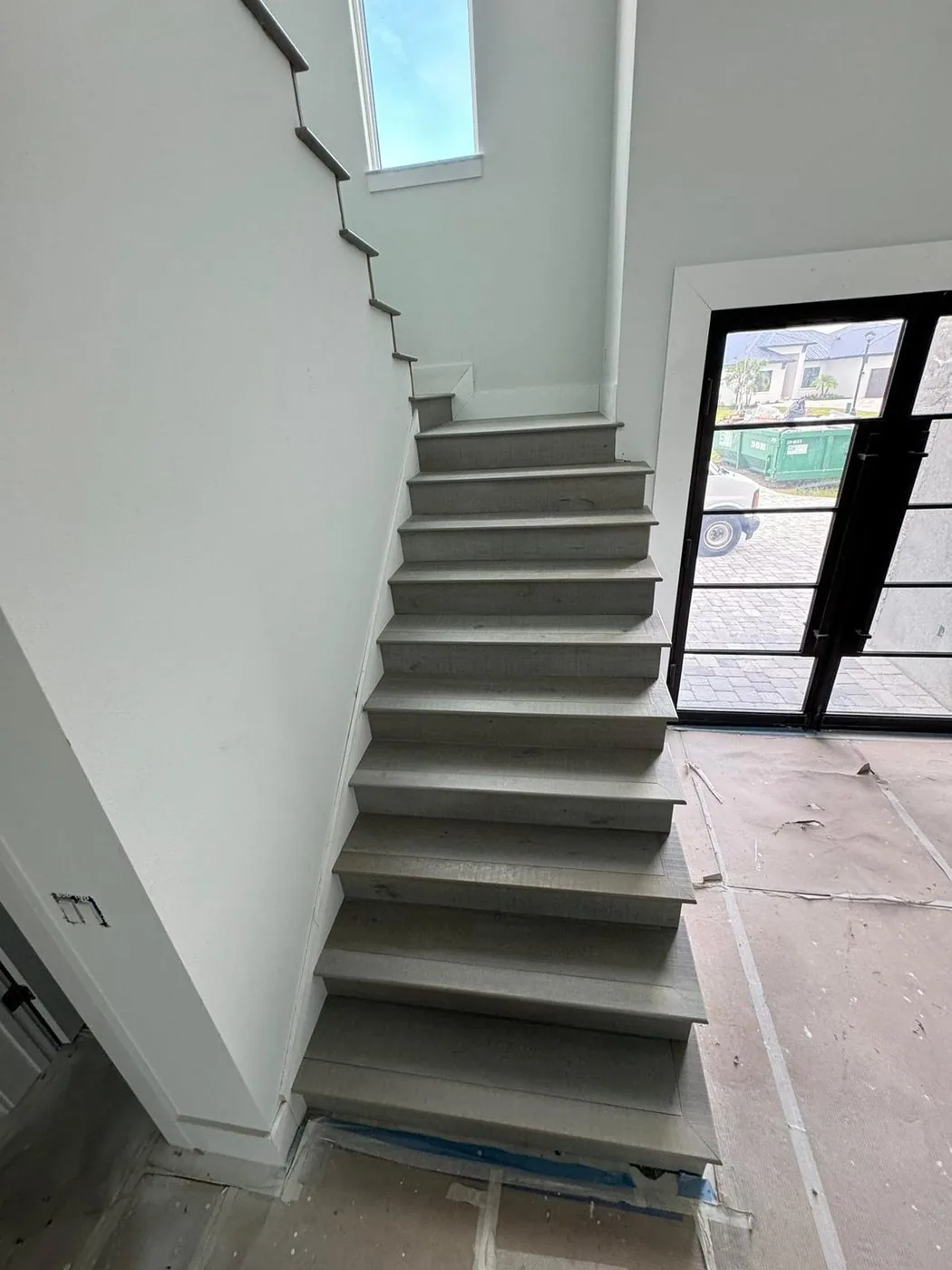 Gray LVP stairs new construction